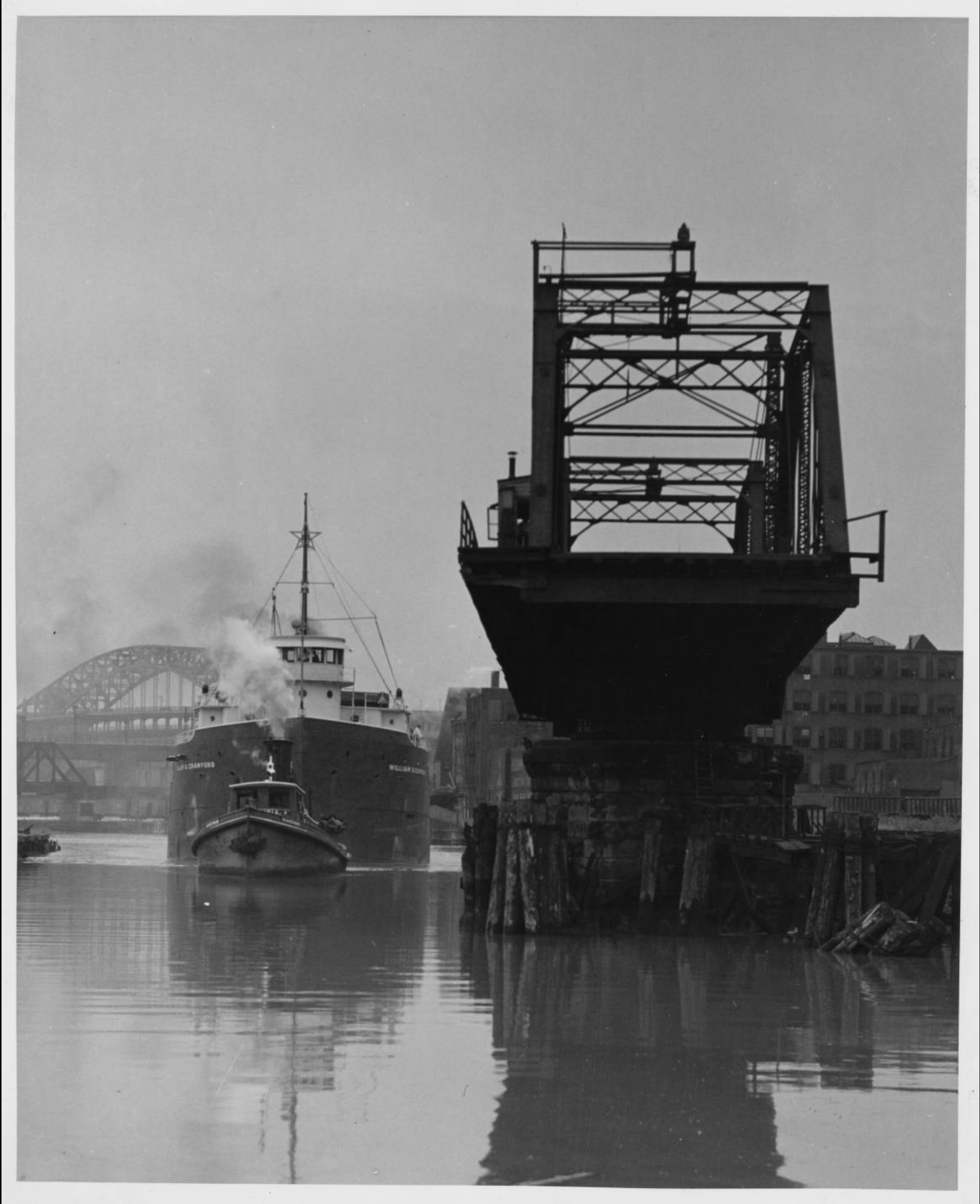 Black and white photograph of a swing bridge in the open position.