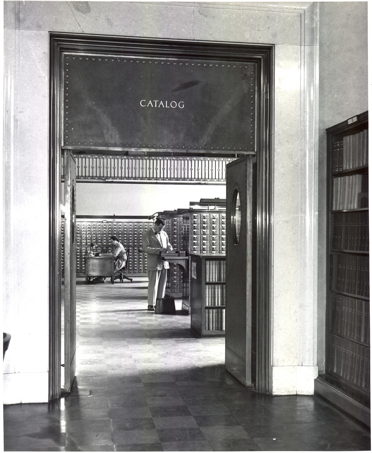 Black and white photograph of the Public Catalog room, located just inside the front entrance to the Main Library. Photo taken in 1955.