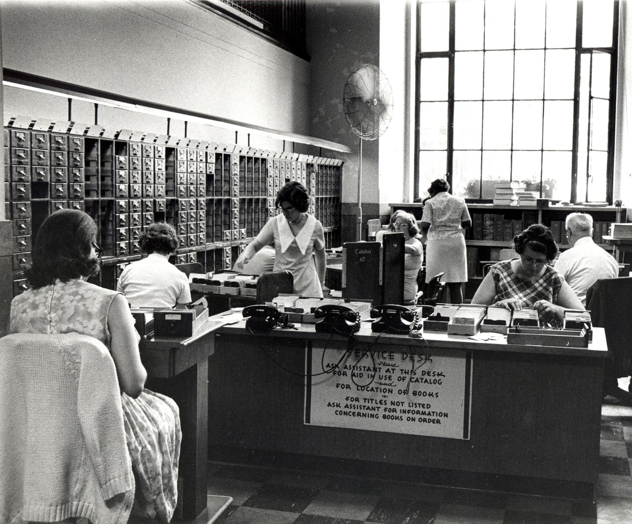 Black and white photo of the Service Desk/Workroom area, also from 1973.