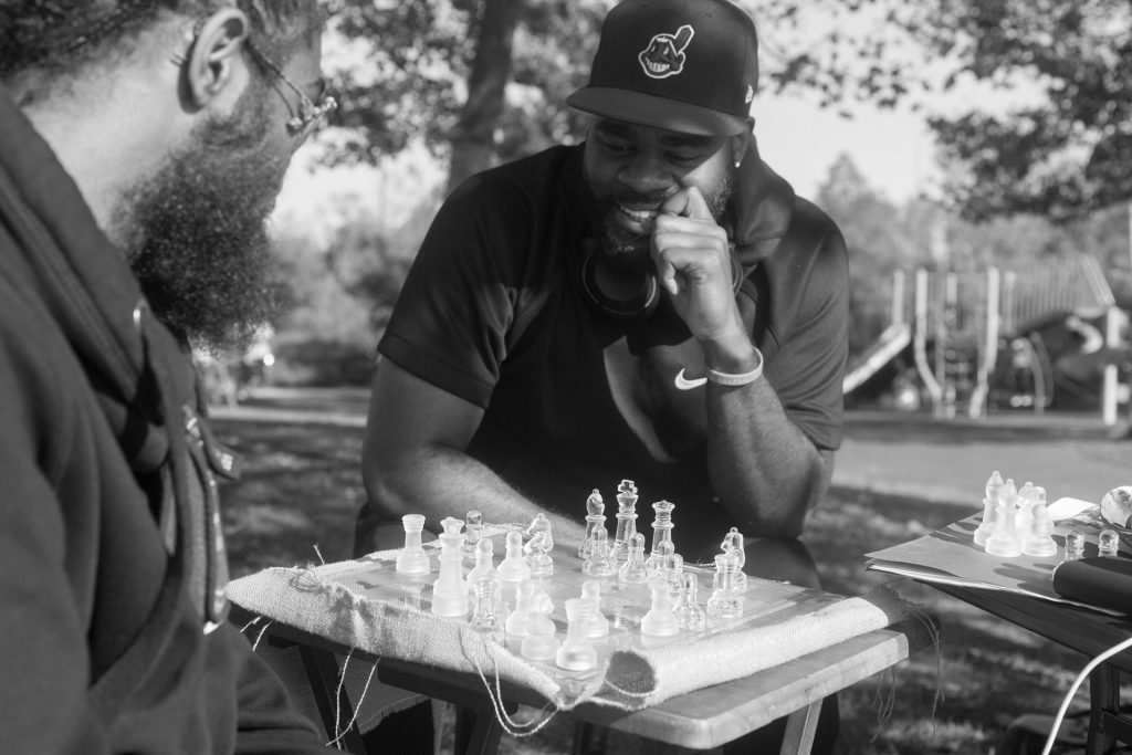 Two men in park playing chess