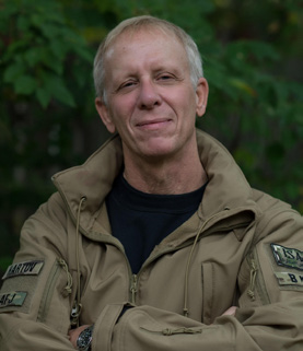 Steven Hartov in an Army-green jacket