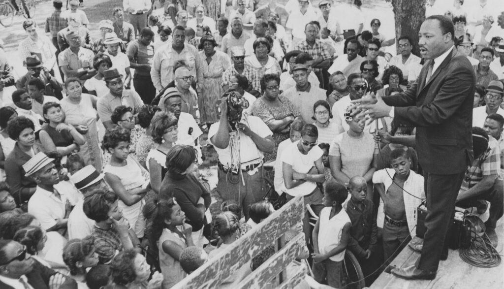 The photograph depicts Dr. King speaking to a crowd in Cleveland on July 29, 1967.